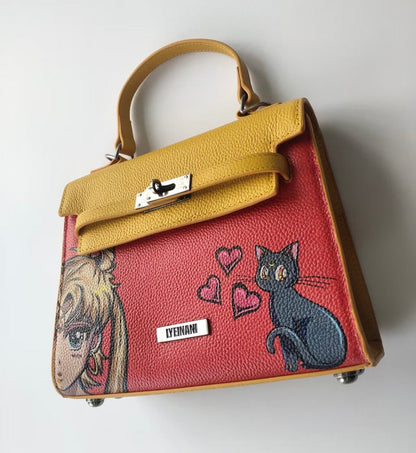 Designer handbag with cat and dog illustrations on a white background